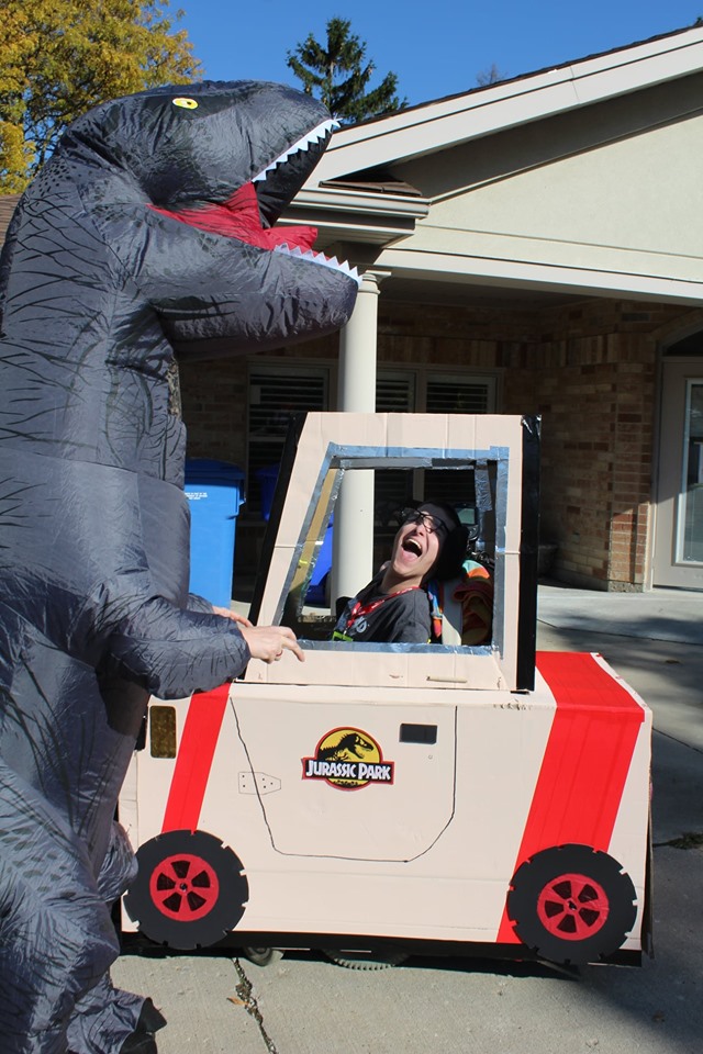 Photo of a Jurassic Park recreating. Staff wearing dinosaur costume.