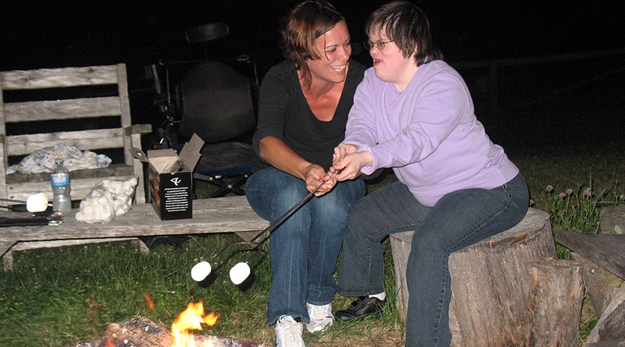 Photo of two people roasting marshmallows