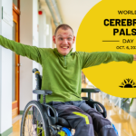 Male with cerebral palsy in a wheelchair wearing a green sweater with his arms out smiling. Yellow circle with the text world cerebral palsy day october 6 2024 with a green ribbon