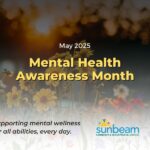 Mental Health Awareness Month in yellow writing with wild flowers in background, Sunbeam Community and Developmental Services logo in white fade on lower half of page.